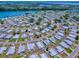 Aerial view showcasing the community layout, including nearby lake and amenities at 1437 Apache Cir, Tavares, FL 32778