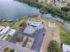 Expansive aerial shot featuring a community center with a pool, parking, and waterfront access at 1437 Apache Cir, Tavares, FL 32778