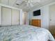 Bright bedroom with a ceiling fan and closet at 1437 Apache Cir, Tavares, FL 32778