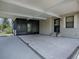 Spacious carport with an attached screened-in porch area with tile flooring and a side entry door at 1437 Apache Cir, Tavares, FL 32778