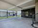 Large carport with an attached screened-in porch and access to the home's side entrance at 1437 Apache Cir, Tavares, FL 32778