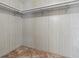 This empty closet features carpet flooring, wood paneled walls, and an overhead shelving rack at 1437 Apache Cir, Tavares, FL 32778