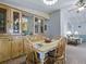 Dining area open to the living room, featuring wooden furniture at 1437 Apache Cir, Tavares, FL 32778