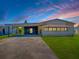 Charming single-story home featuring a carport, well-maintained lawn, and a cozy front porch at 1437 Apache Cir, Tavares, FL 32778