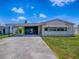 Exterior view of the home, featuring a driveway, covered parking, and awning at 1437 Apache Cir, Tavares, FL 32778