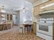 Eat-in kitchen featuring a stove and bar seating at 1437 Apache Cir, Tavares, FL 32778