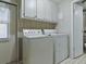 Functional laundry room with washer, dryer, and cabinetry at 1437 Apache Cir, Tavares, FL 32778