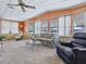 Bright living room with large windows, comfortable seating, and a ceiling fan at 1437 Apache Cir, Tavares, FL 32778