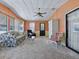 Spacious living room with plenty of natural light, carpet flooring, and a ceiling fan at 1437 Apache Cir, Tavares, FL 32778