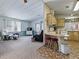 Spacious living room open to the eat-in kitchen with bar seating at 1437 Apache Cir, Tavares, FL 32778