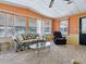 Cozy living room featuring large windows, carpet flooring, and ample seating at 1437 Apache Cir, Tavares, FL 32778