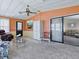 Open living room with a sliding glass door, carpet, ceiling fan and furniture at 1437 Apache Cir, Tavares, FL 32778