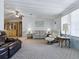 Well-lit living room showcasing a view into the dining area with plush furnishings and comfortable seating at 1437 Apache Cir, Tavares, FL 32778