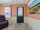 Living room with carpet flooring, multiple windows, and a view of the kitchen through the window at 1437 Apache Cir, Tavares, FL 32778