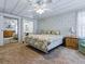 Spacious main bedroom features a ceiling fan, carpet flooring, a large closet, and access to the bathroom at 1437 Apache Cir, Tavares, FL 32778