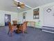 The back porch offers a ceiling fan, table with seating, and is great for relaxing and entertaining at 1437 Apache Cir, Tavares, FL 32778