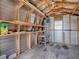 Interior view of shed with shelving, pegboard, ladder, and a small work bench at 1437 Apache Cir, Tavares, FL 32778