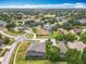 Scenic aerial view of a neighborhood with lush greenery, ponds, and well-maintained streets at 1473 Lakemist Ln, Clermont, FL 34711