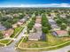 Overhead shot of a residential neighborhood with mature trees lining the streets at 1473 Lakemist Ln, Clermont, FL 34711