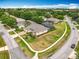 Aerial view shows the home with enclosed pool in a quiet neighborhood and nice landscaping at 1473 Lakemist Ln, Clermont, FL 34711