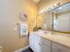 Bright bathroom featuring a white vanity, decorative mirror, and coastal-themed accents at 1473 Lakemist Ln, Clermont, FL 34711
