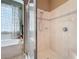 Bathroom with a large glass-enclosed shower and a soaking tub next to a window at 1473 Lakemist Ln, Clermont, FL 34711