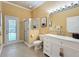 Bright bathroom with a glass-enclosed shower, white vanity with marble countertop, and access to the pool at 1473 Lakemist Ln, Clermont, FL 34711