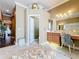 Bright bathroom with vanity, lighting, and decorative ottoman seating area near an open doorway at 1473 Lakemist Ln, Clermont, FL 34711