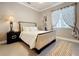 Well-lit bedroom featuring a queen bed with a padded headboard, modern decor, and a geometric rug at 1473 Lakemist Ln, Clermont, FL 34711