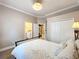 Bright bedroom with a queen bed, closet space, and access to an en-suite bathroom at 1473 Lakemist Ln, Clermont, FL 34711