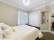Comfortable bedroom features a queen bed with white bedding, closet, and built-in display shelves at 1473 Lakemist Ln, Clermont, FL 34711