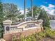 The 'Legends Clubhouse' entrance featuring a stone monument sign and well-maintained landscaping at 1473 Lakemist Ln, Clermont, FL 34711