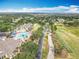 Aerial view of the community amenities including pool, golf course, clubhouse, and tennis courts at 1473 Lakemist Ln, Clermont, FL 34711