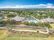 Aerial shot highlighting the community's pool, clubhouse, tennis courts and golf driving range at 1473 Lakemist Ln, Clermont, FL 34711