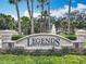 Elegant entrance sign for Legends Golf & Country Club, adorned with palm trees and flowers at 1473 Lakemist Ln, Clermont, FL 34711