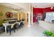 Elegant dining room featuring a chandelier, decorative mirror, and seating for six at 1473 Lakemist Ln, Clermont, FL 34711