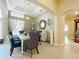 Bright dining room features a stylish chandelier, decorative mirror, and tiled flooring at 1473 Lakemist Ln, Clermont, FL 34711