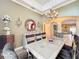 Elegant dining area featuring a chandelier, modern decor, and stylish furnishings at 1473 Lakemist Ln, Clermont, FL 34711