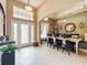 Open concept, combined dining and living area with tile floors and front door view at 1473 Lakemist Ln, Clermont, FL 34711