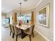 Elegant dining room featuring a decorative chandelier and a large window at 1473 Lakemist Ln, Clermont, FL 34711