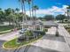 Gated community entrance showcasing lush landscaping, brick roads, and a secure entry point at 1473 Lakemist Ln, Clermont, FL 34711
