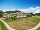 Charming single-story home with lush landscaping, mature trees, and well-maintained lawn at 1473 Lakemist Ln, Clermont, FL 34711