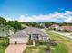 Lovely single-Gathering home featuring a three-car garage and a beautiful brick driveway at 1473 Lakemist Ln, Clermont, FL 34711