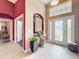 Grand foyer with red accent wall, patterned tile flooring, and decorative lighting at 1473 Lakemist Ln, Clermont, FL 34711