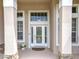 Close up of front door with transom windows and decorative glass at 1473 Lakemist Ln, Clermont, FL 34711