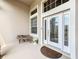 Detailed front door with transom windows and comfortable bench at 1473 Lakemist Ln, Clermont, FL 34711