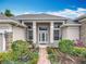 Attractive home entrance featuring a brick walkway and symmetrical landscaping at 1473 Lakemist Ln, Clermont, FL 34711