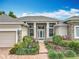 Inviting front entrance with brick pathway, lush landscaping and stone facade accents at 1473 Lakemist Ln, Clermont, FL 34711