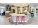 Open kitchen design with an island, barstool seating, and stainless steel appliances at 1473 Lakemist Ln, Clermont, FL 34711