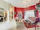 Bright living room with a decorative rug, chandelier, tile flooring, and access to dining room at 1473 Lakemist Ln, Clermont, FL 34711